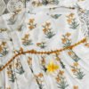 IMG_20260405_114538681 White cotton peplum top with yellow daffodil print