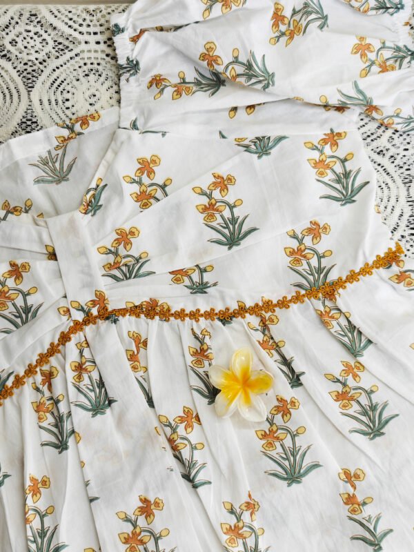 IMG_20260405_114538681 White cotton peplum top with yellow daffodil print