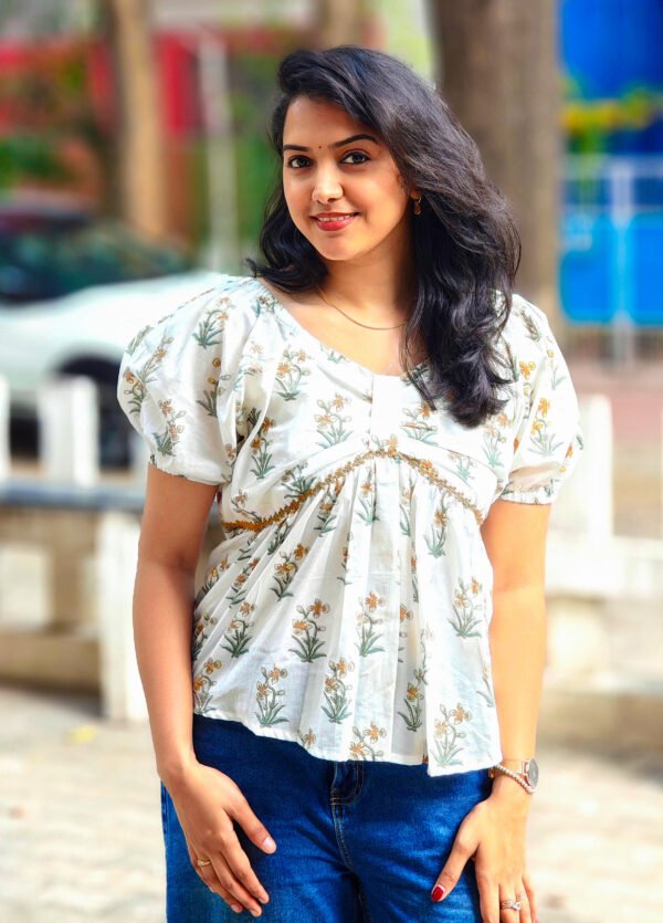 IMG_20260428_085138015 (1) White cotton peplum top with yellow daffodil print
