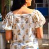 IMG_20260428_090824777 (1) White cotton peplum top with yellow daffodil print