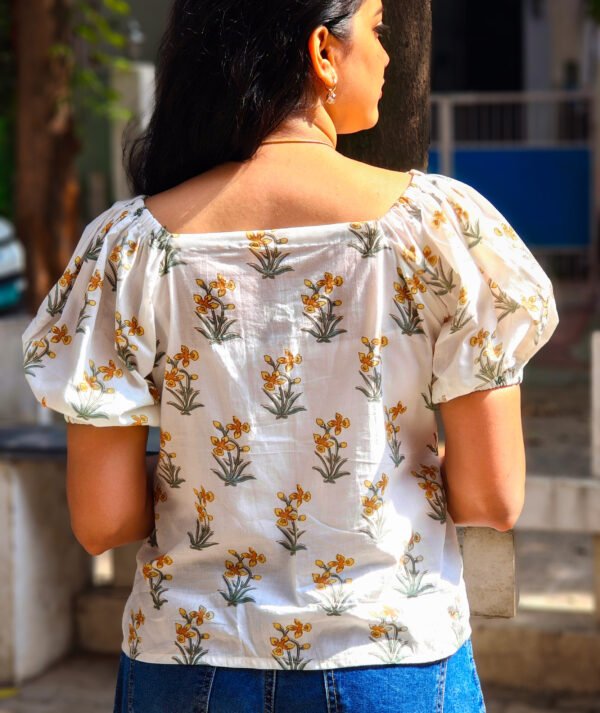 IMG_20260428_090824777 (1) White cotton peplum top with yellow daffodil print
